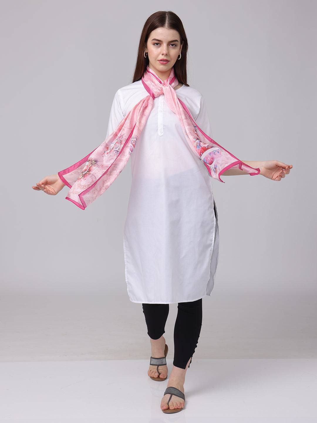 Front view of pink cursive script patterned scarf styled with white dress.