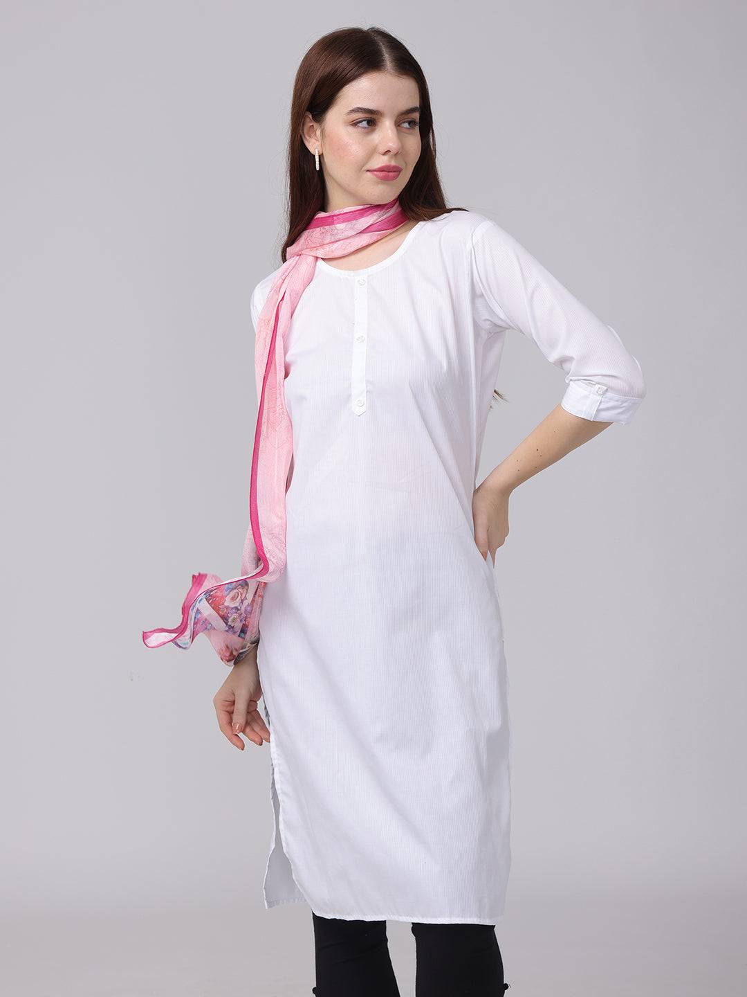 Model posing with pink cursive script patterned scarf and white dress.