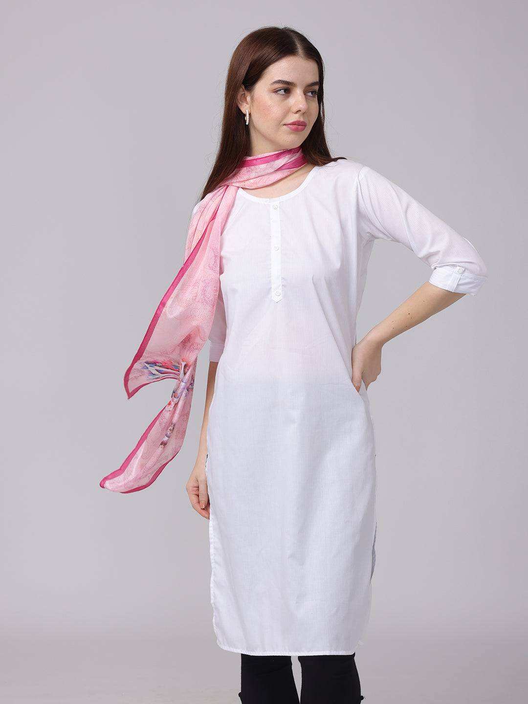 Model wearing pink cursive script patterned scarf with white outfit.