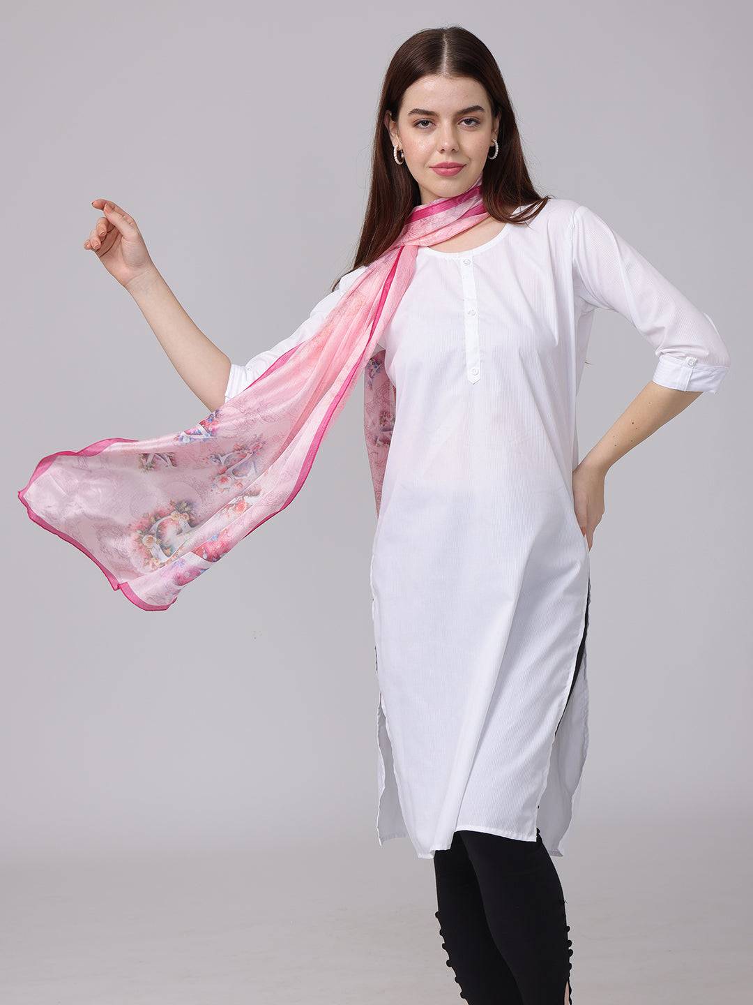 Pink cursive script patterned scarf elegantly styled with white outfit.