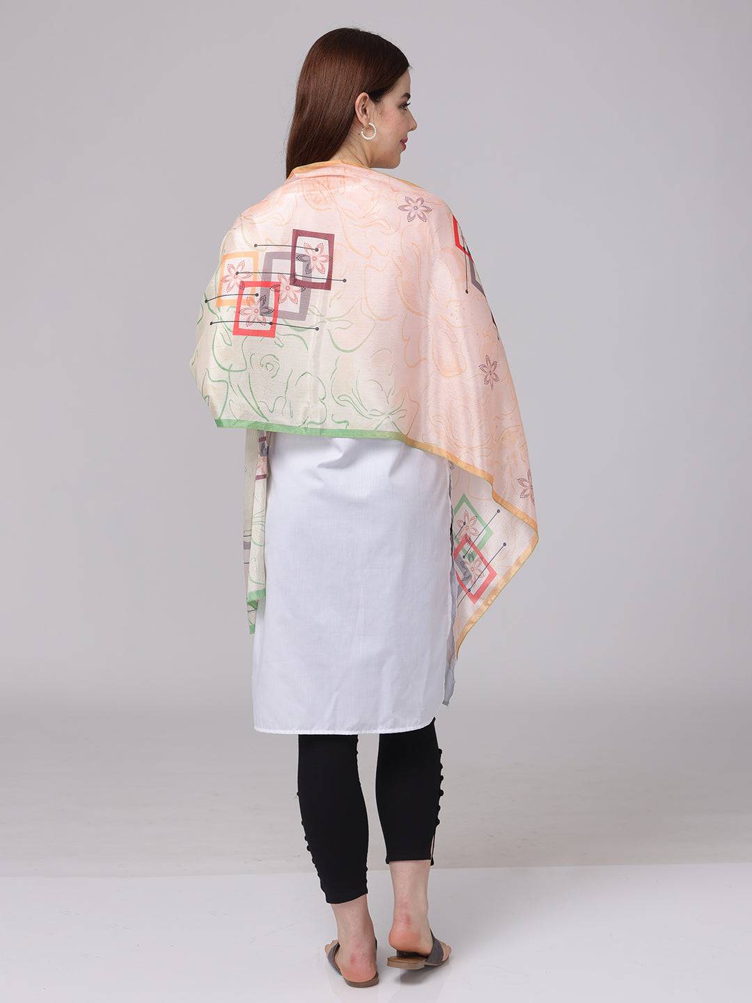 Back view of floral geometric pastel scarf draped over shoulders.