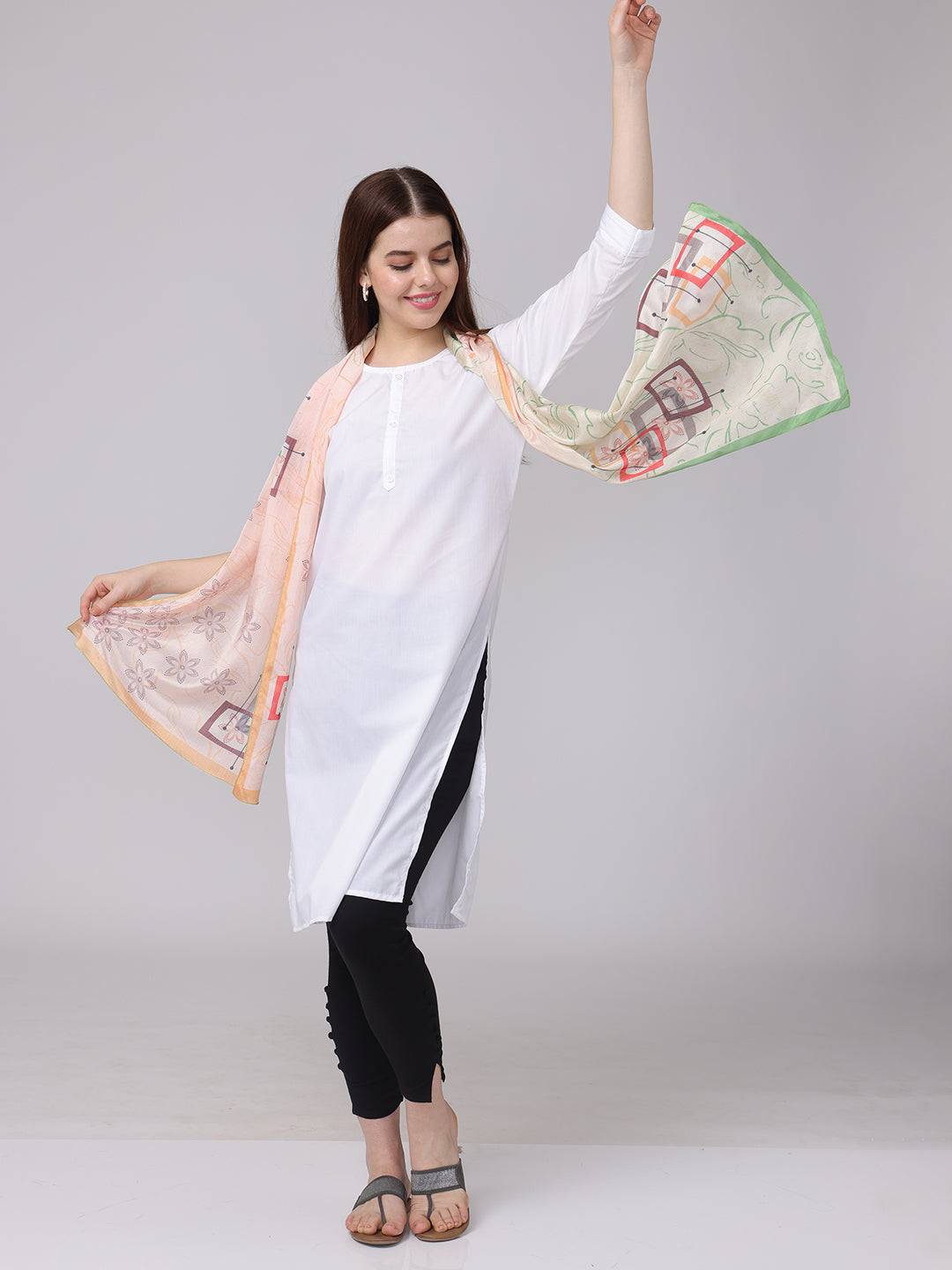 Floral geometric pastel scarf elegantly draped with arms extended.