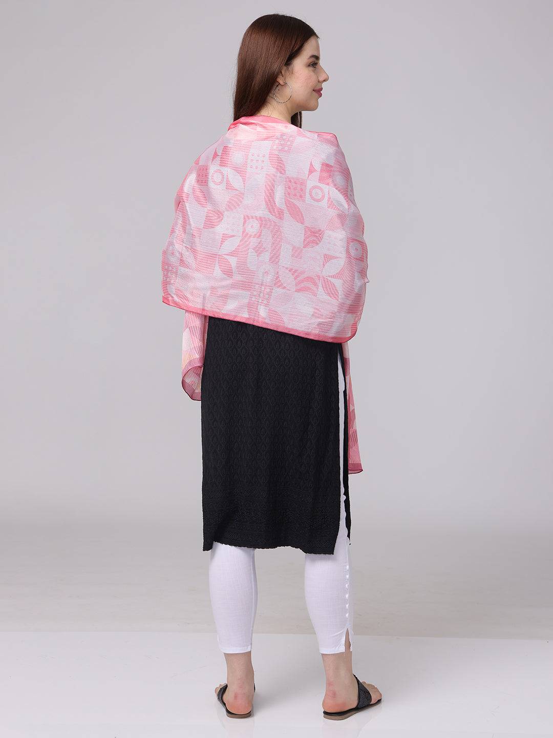 Back view of pink geometric scarf on black dress.