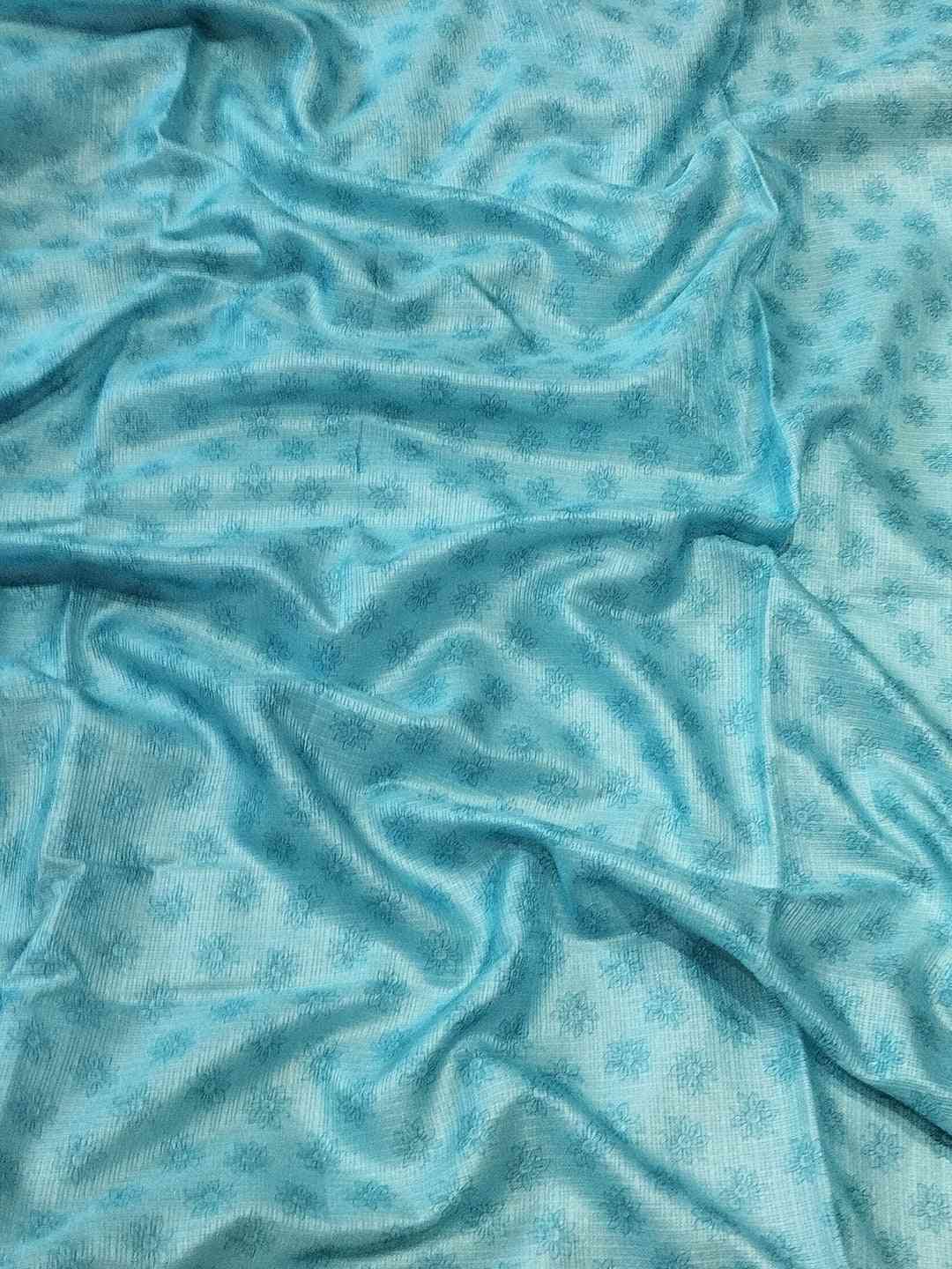 Blue fabric with subtle floral pattern, close-up view