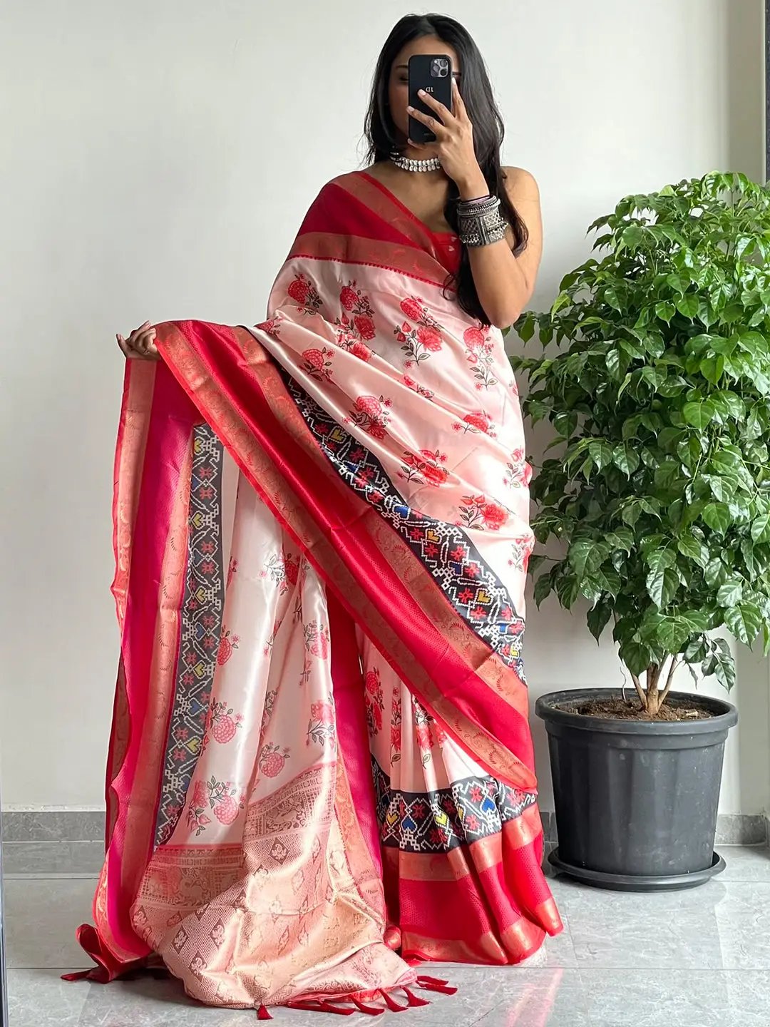 Stylish soft silk saree with intricate red Gadwal border and floral print