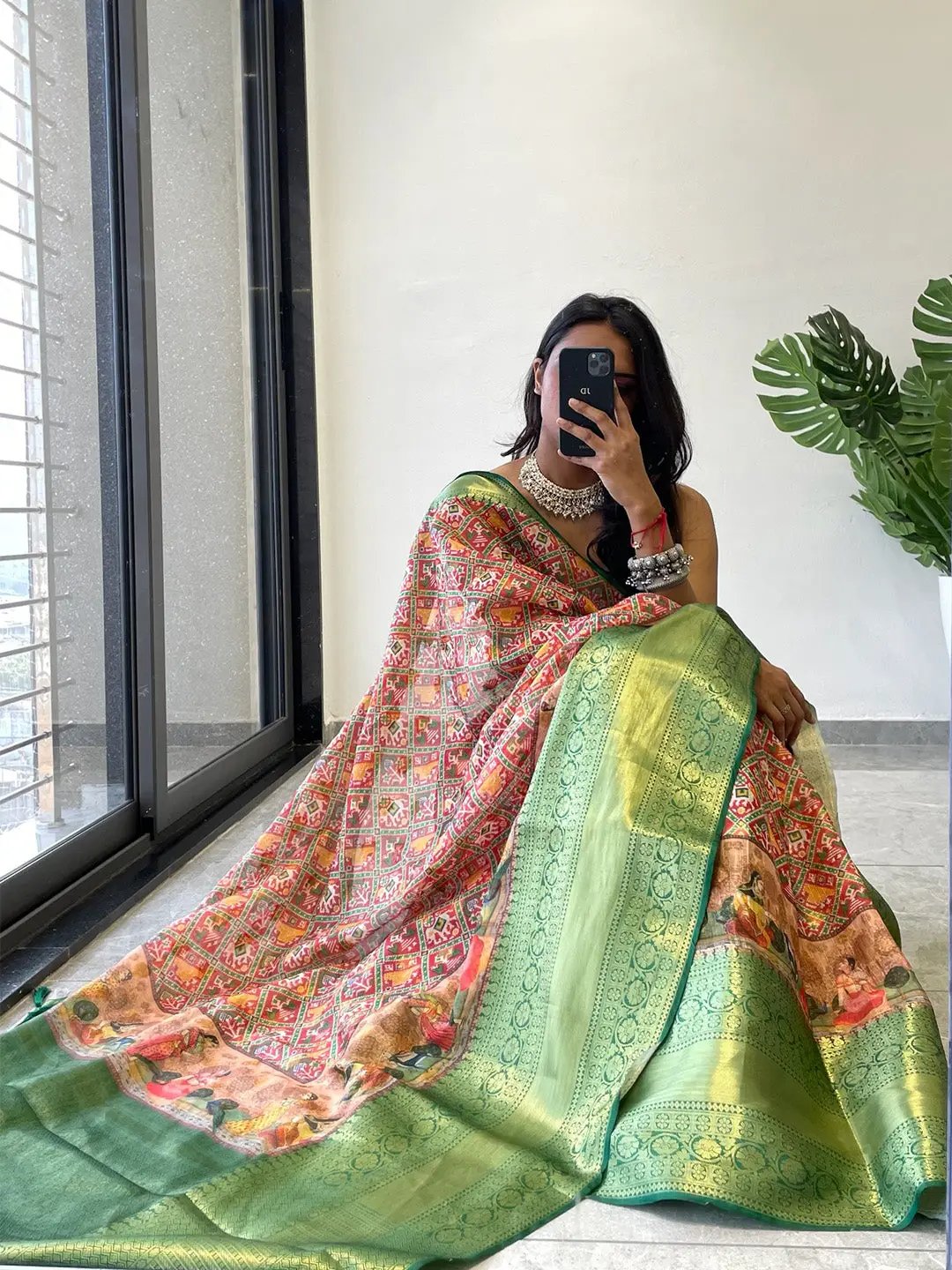 Model showcasing green Patola Moonga silk saree