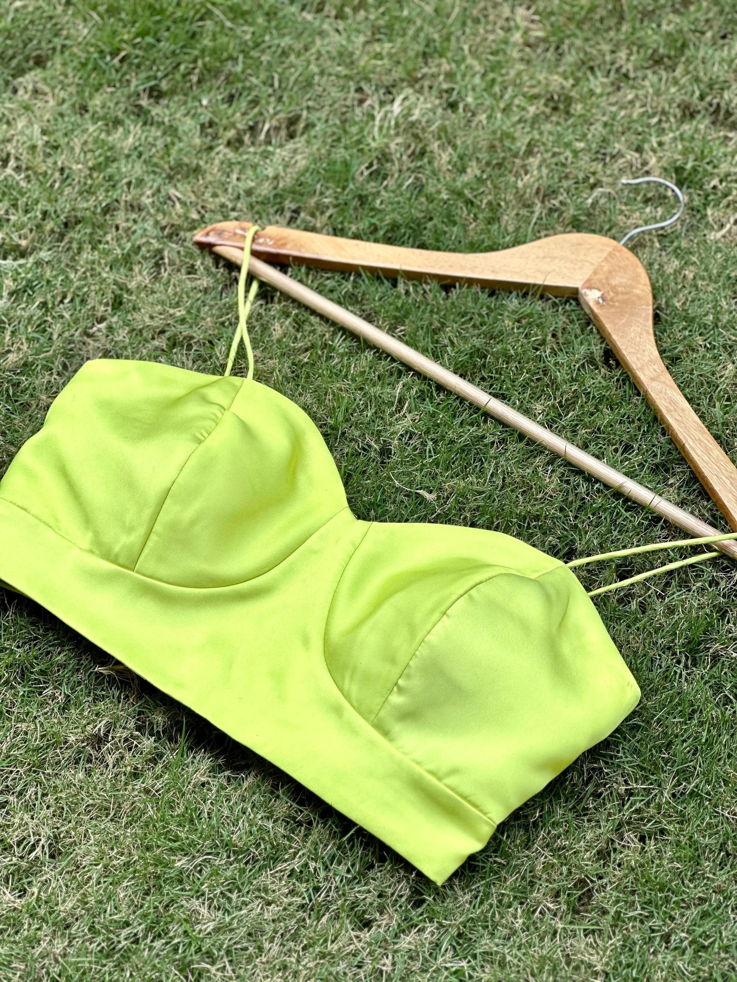 Pista color satin blouse on grass with hanger