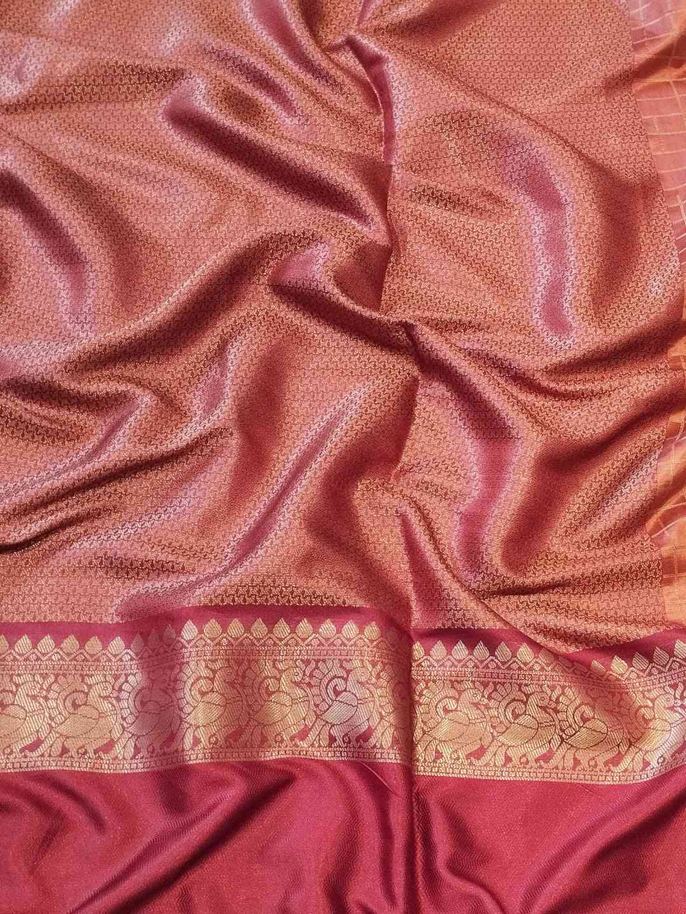 Close-up of maroon Banarasi silk saree fabric and border
