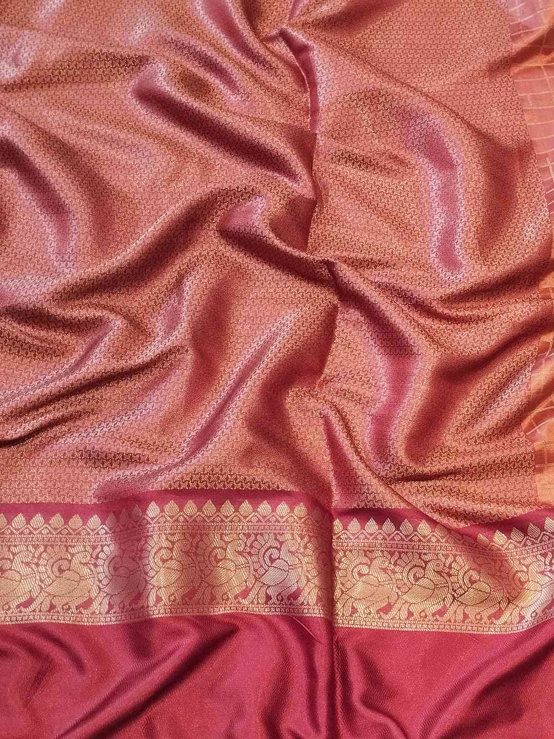 Close-up of maroon Banarasi silk saree fabric and border
