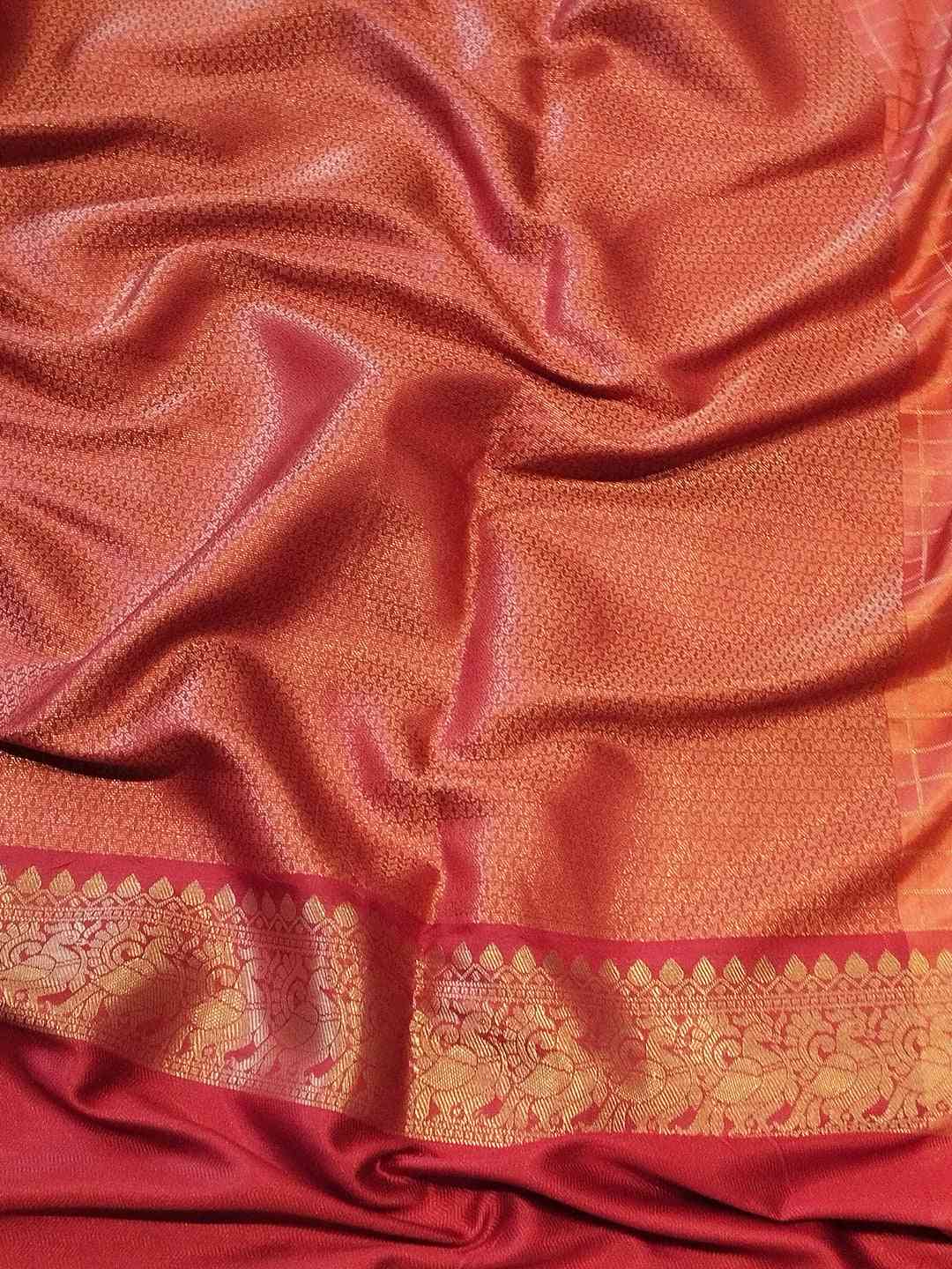 Detailed view of pink Banarasi saree fabric and border