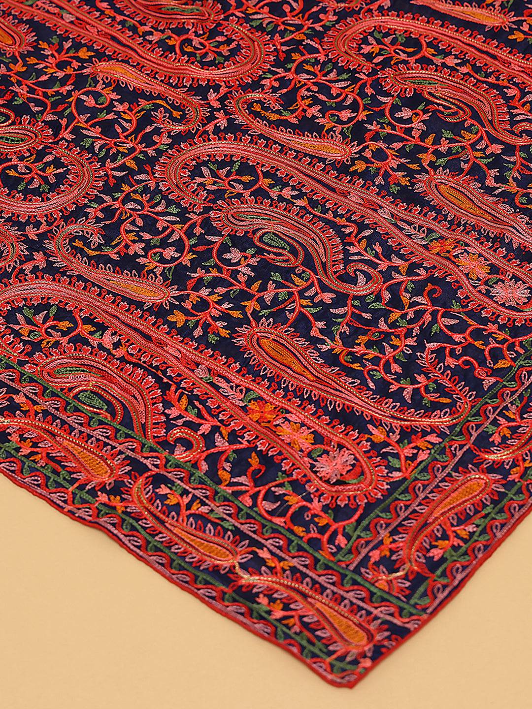 Close-up of navy and red embroidered dupatta with paisley patterns.