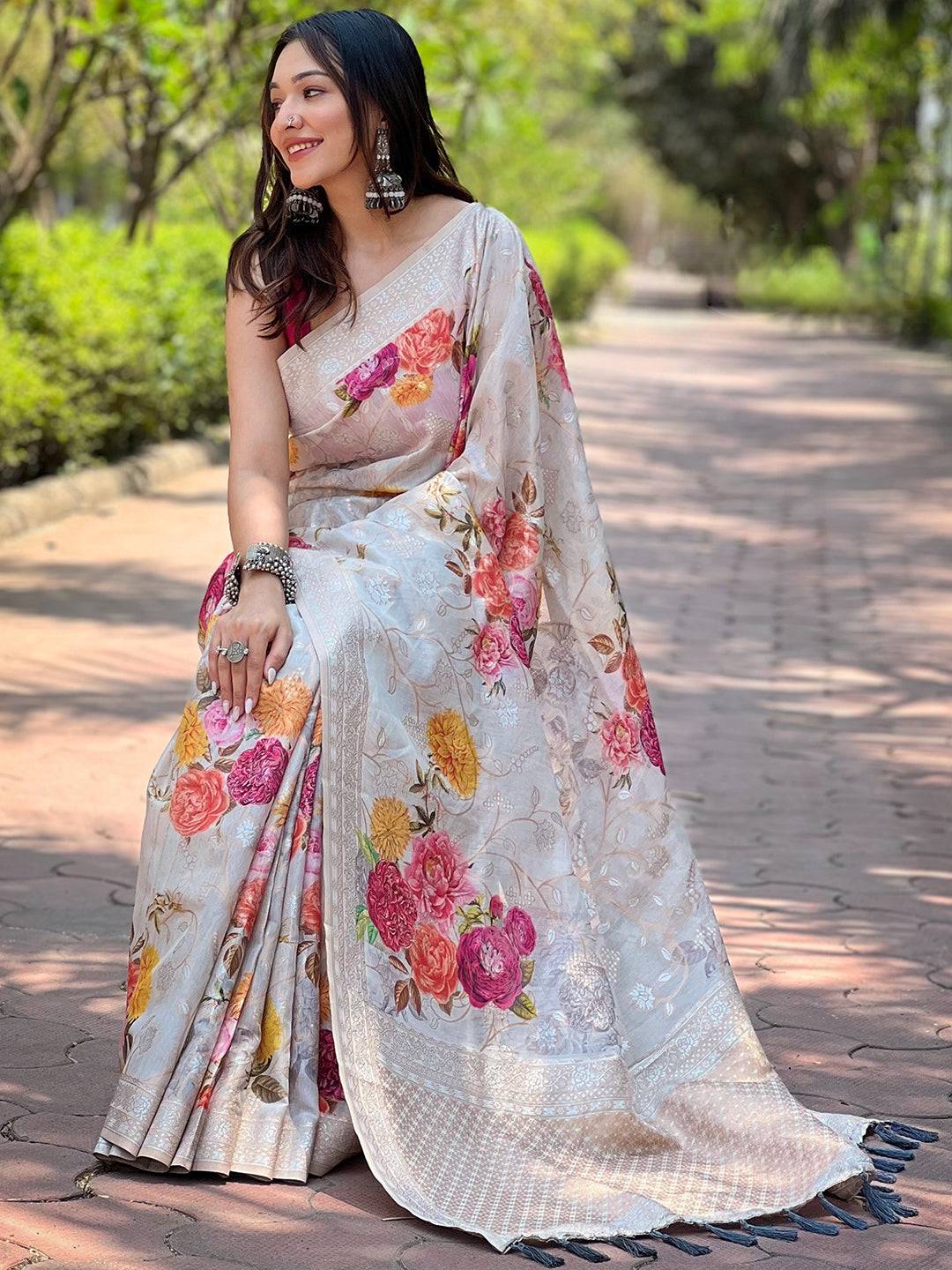 Sitting pose in grey Lakhnavi Bandla Zari saree with floral pattern