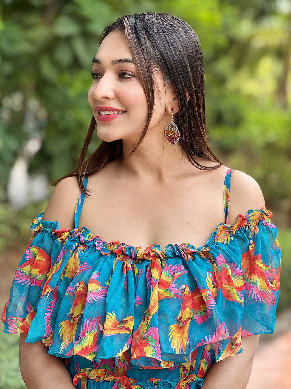 Close-up of blue maxi dress with ruffle neck and bird print