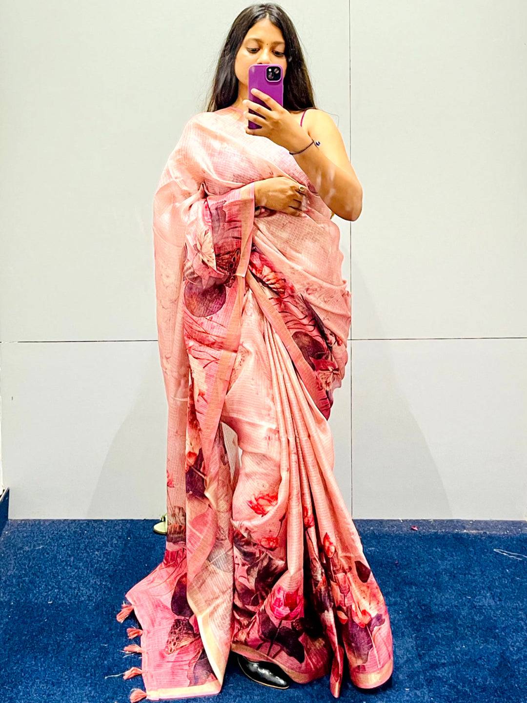 Pink soft Kota Doriya silk saree with floral design worn by woman