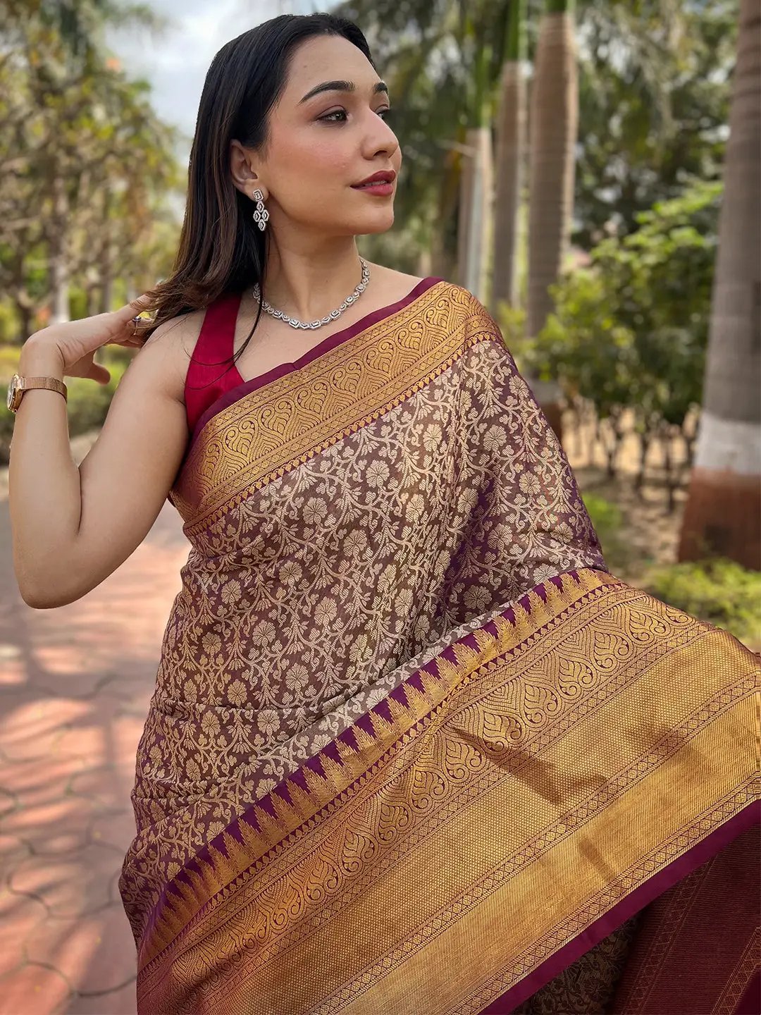 Close-up of jacquard woven work on brown gold tissue saree