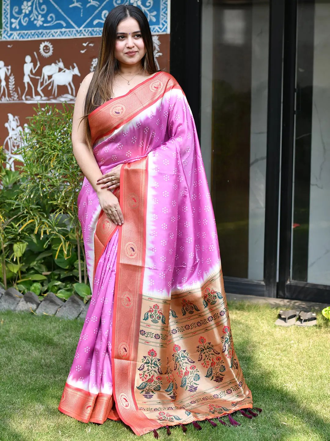 Woman wearing pink Bandhani saree with Paithani border outdoors