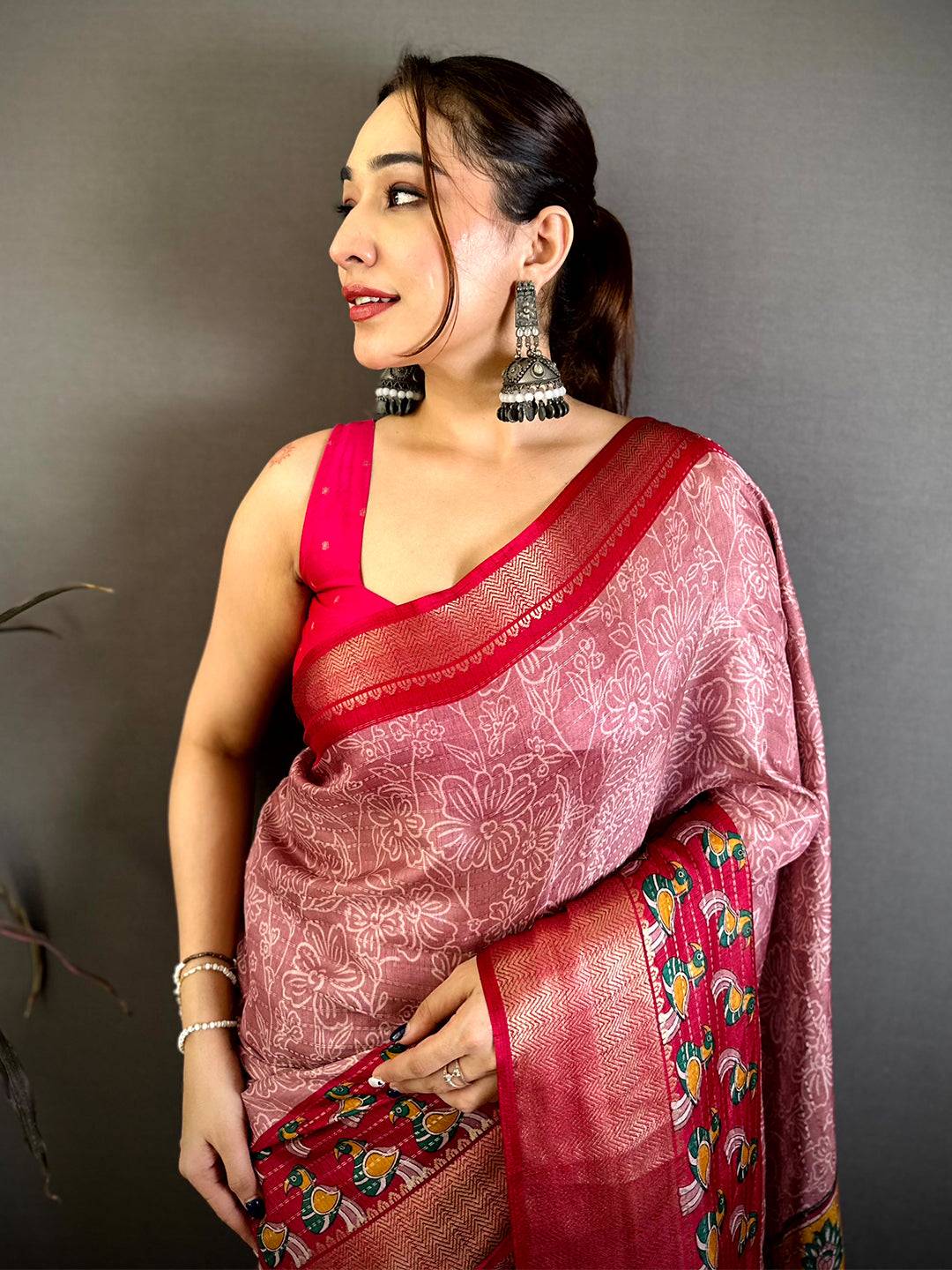 Dusty rose Dola Silk Kalamkari print saree, front drape on a model with red pallu and sleeveless pink blouse