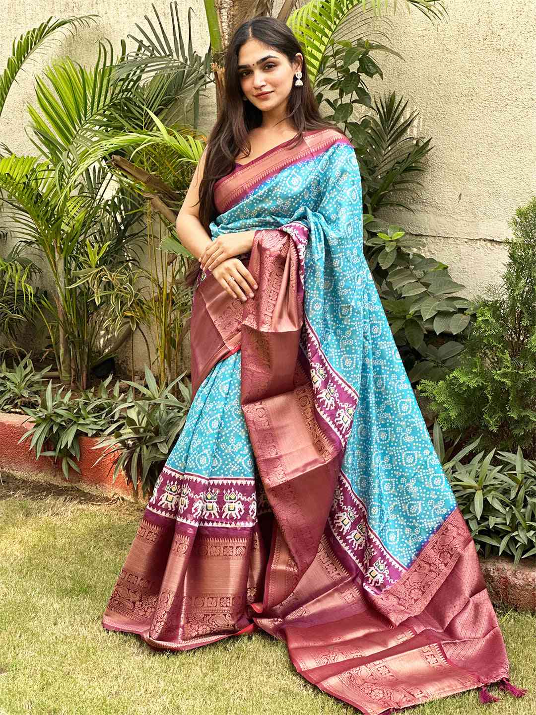 Elegant turquoise Bandhej saree with luxurious Pattu Zari design