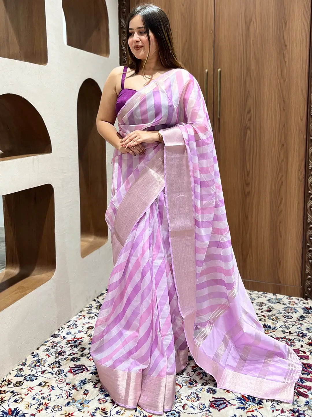 Model wearing pink and purple leheriya organza saree
