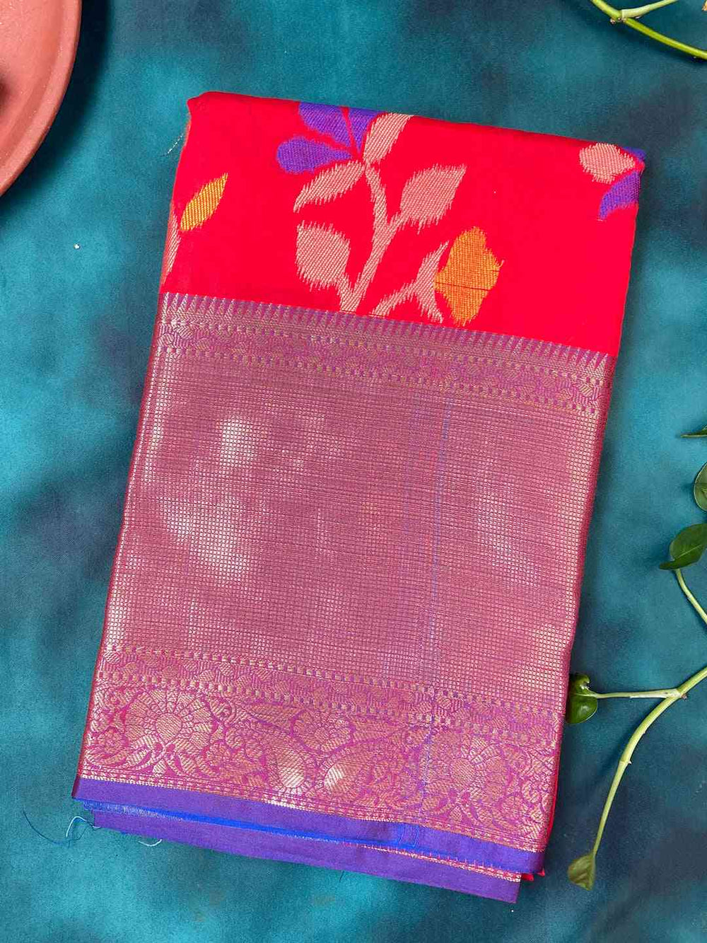 Folded red Banarasi saree with Minakari Ikkat design