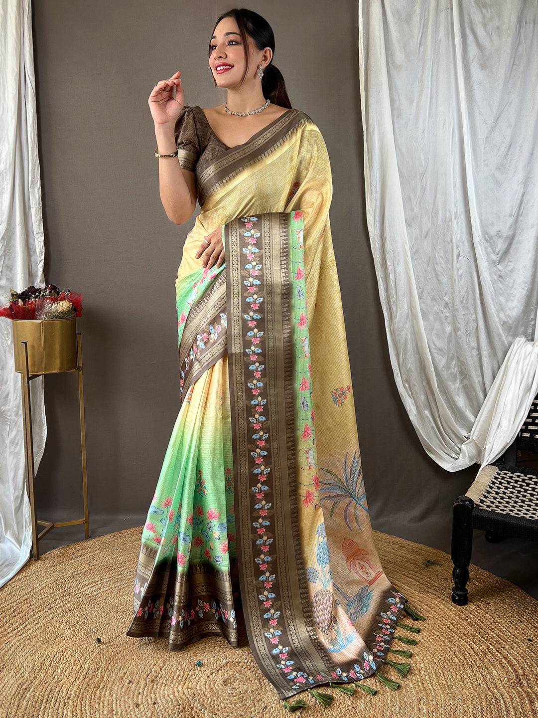 Beige Kota saree featuring rich satin border and floral patterns.