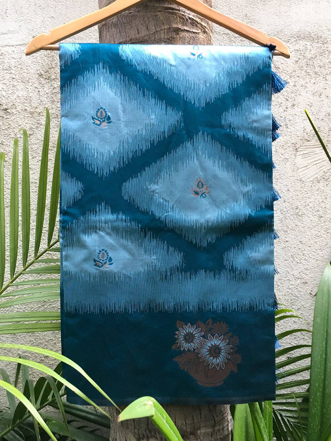 Blue Tussar silk Ikkat saree displayed on hanger