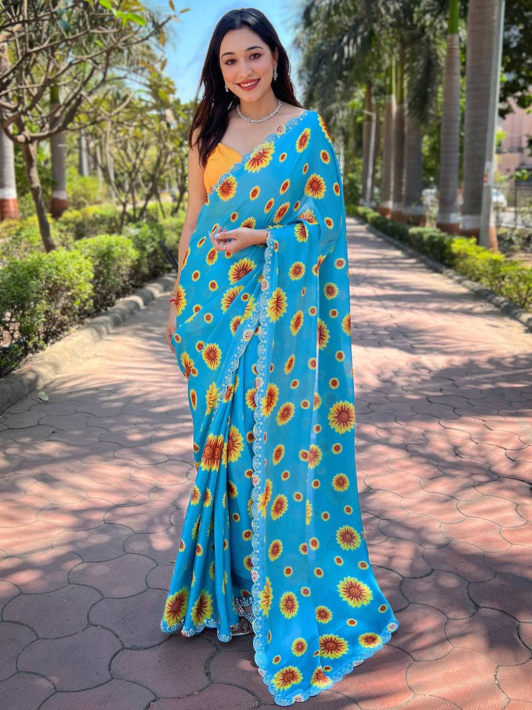 Model wearing blue sunflower print saree with Swarovski border