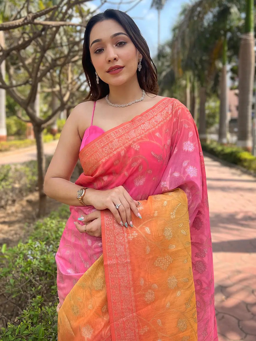 Model wearing pink and orange slub silk saree with zari