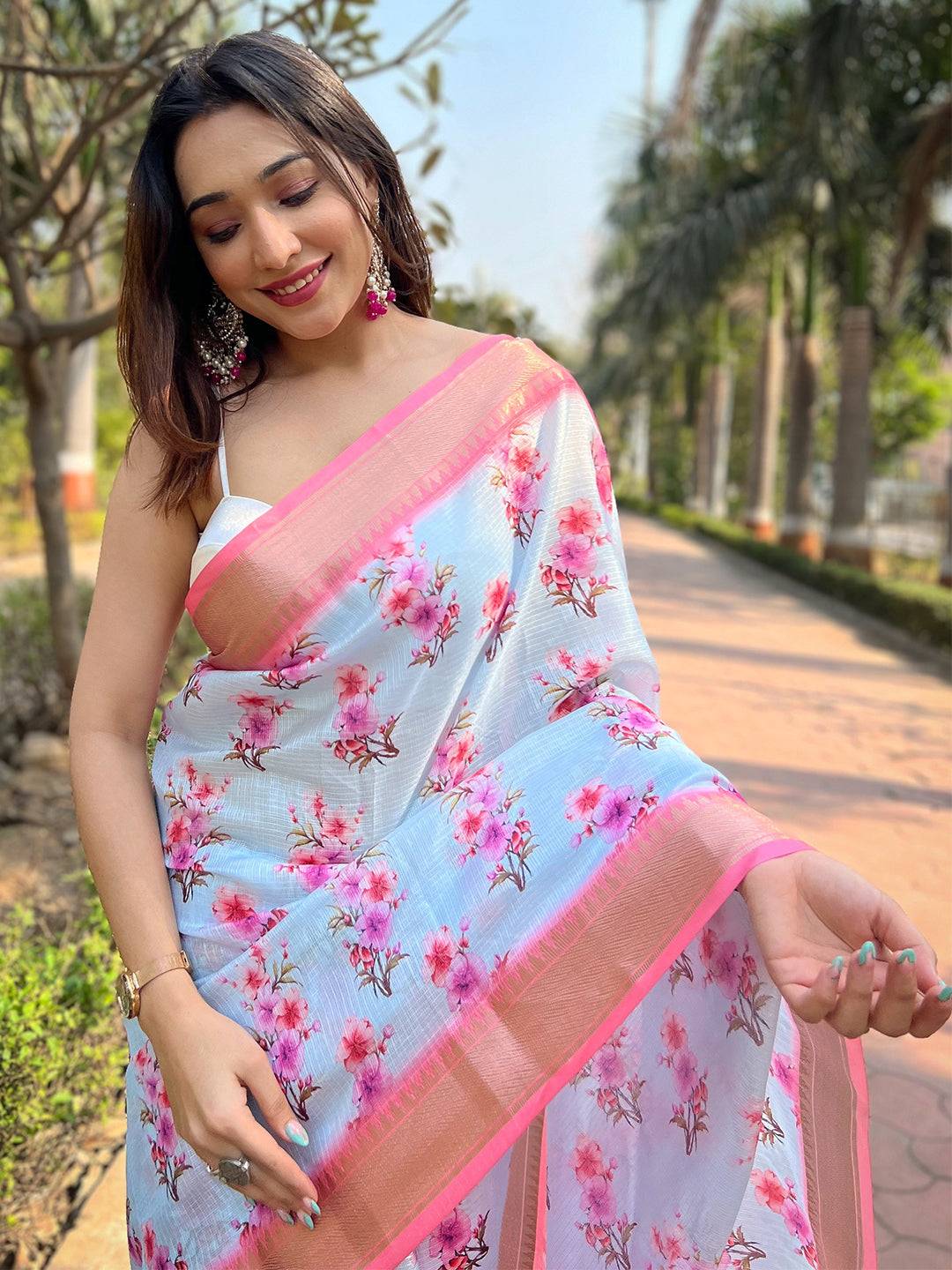Model wearing light blue Kota saree with floral pattern