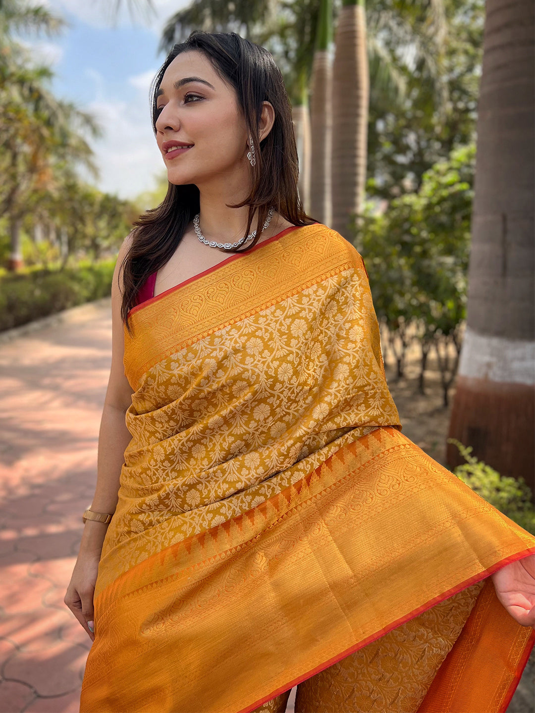 Close-up of yellow gold tissue saree with jacquard woven details