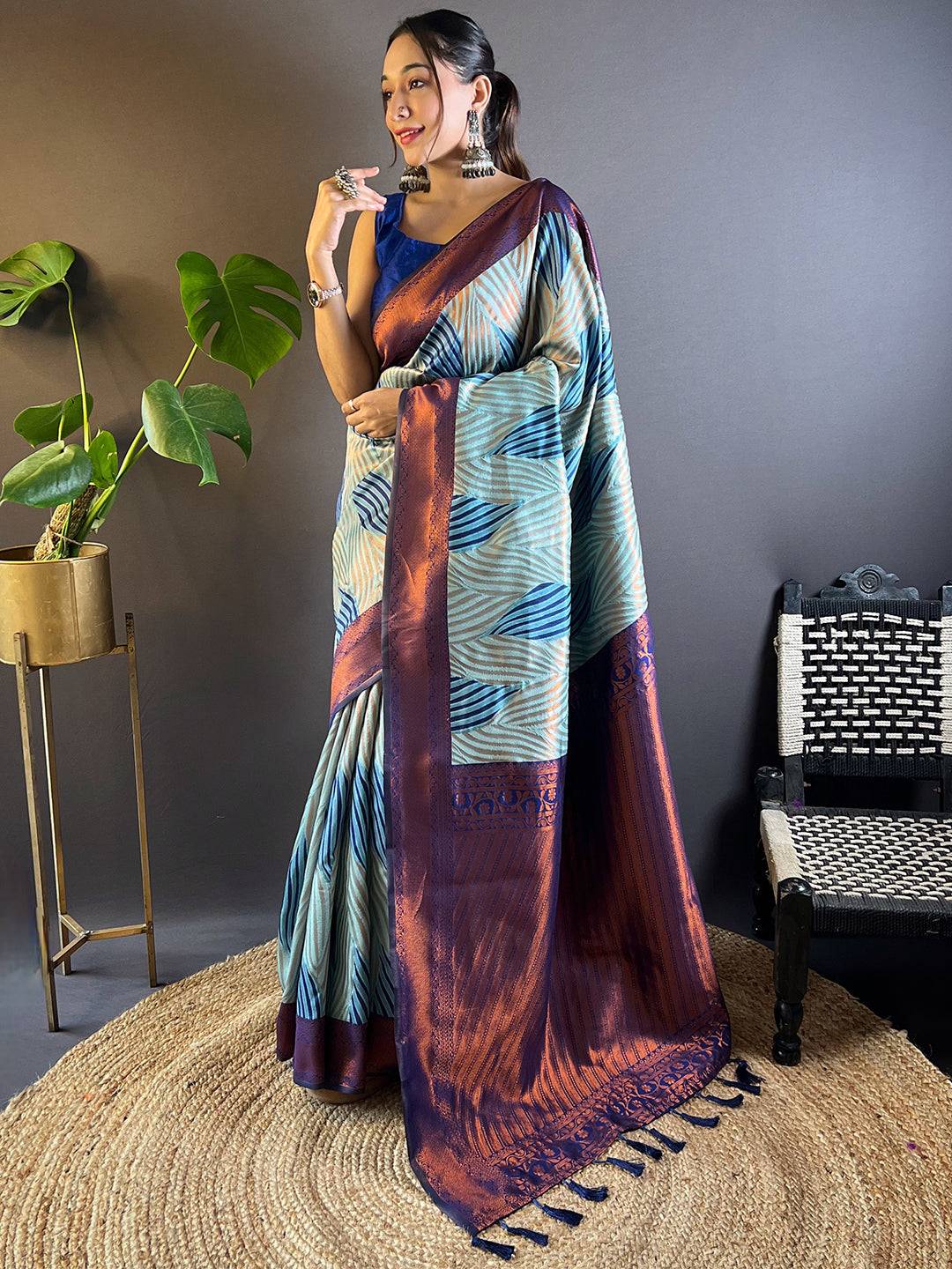 Full view of sky blue Tussar silk Ikkat saree with intricate patterns.