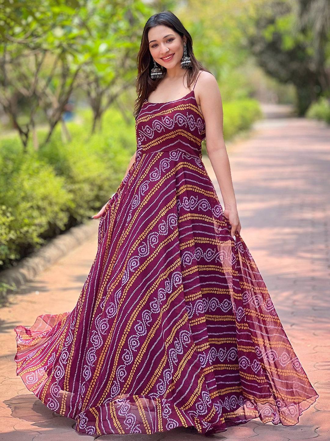Model posing in Wine Bandhej Printed Dress in garden