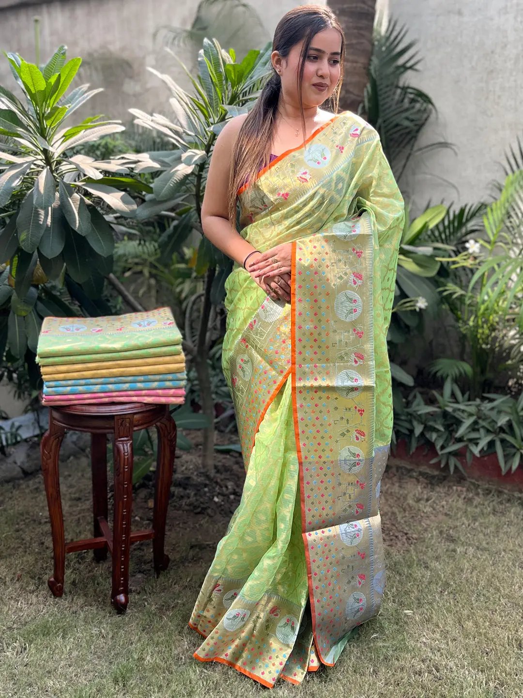 Model showcasing green Kota Doria saree with intricate patterns