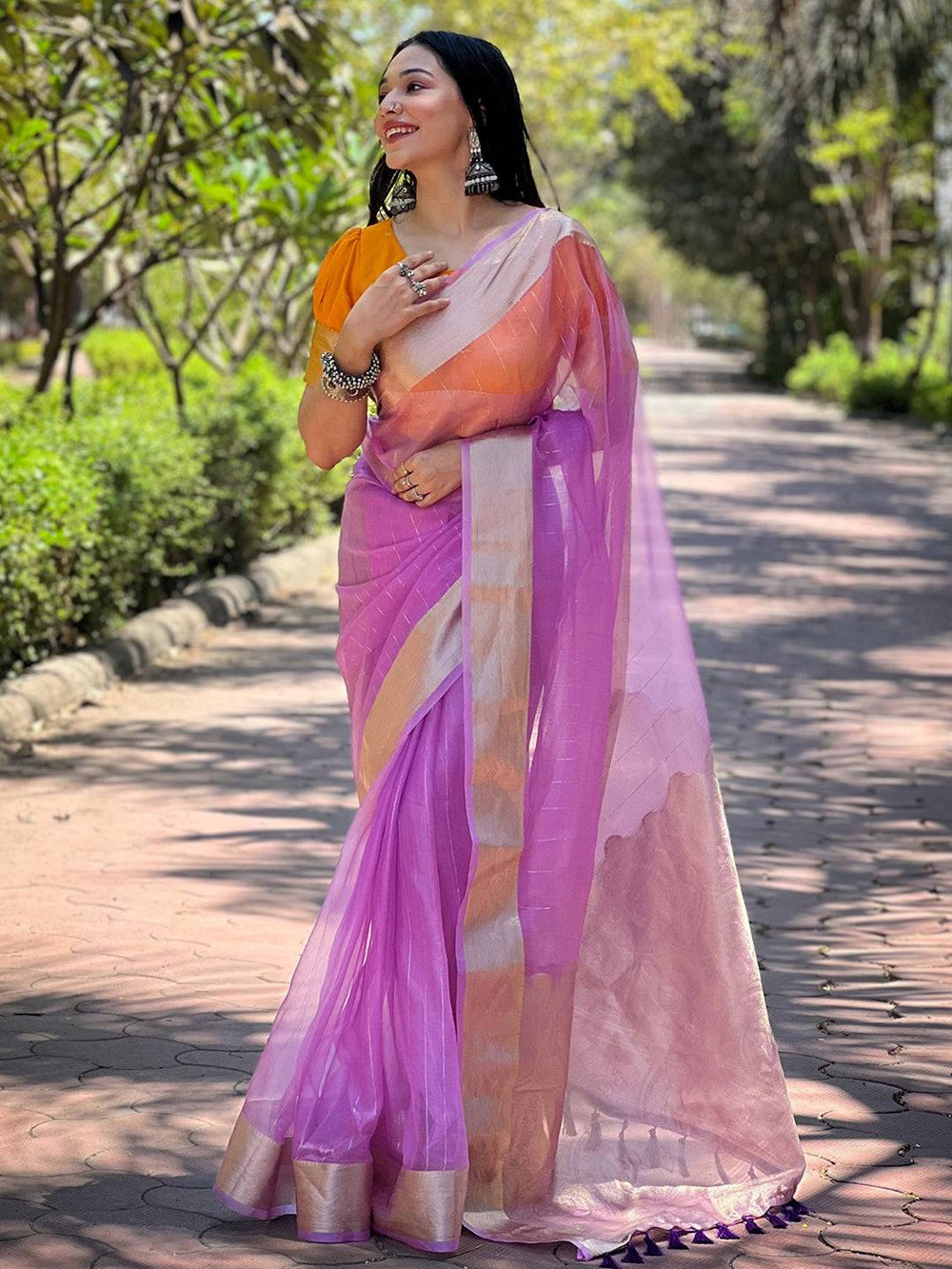 Model in purple organza saree with fine gold zari weaving