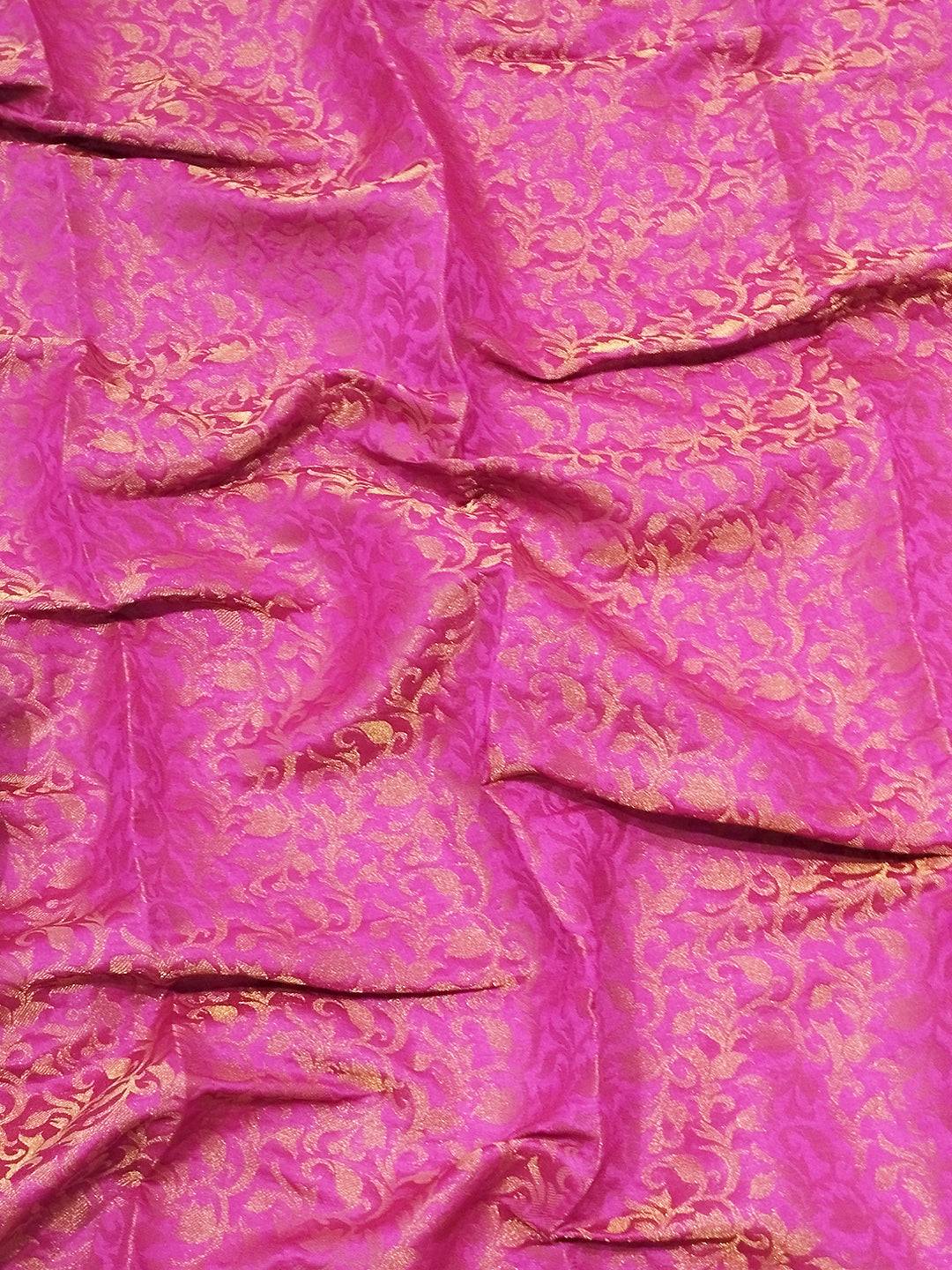 Close-up of pink brocade zari blouse fabric with gold patterns