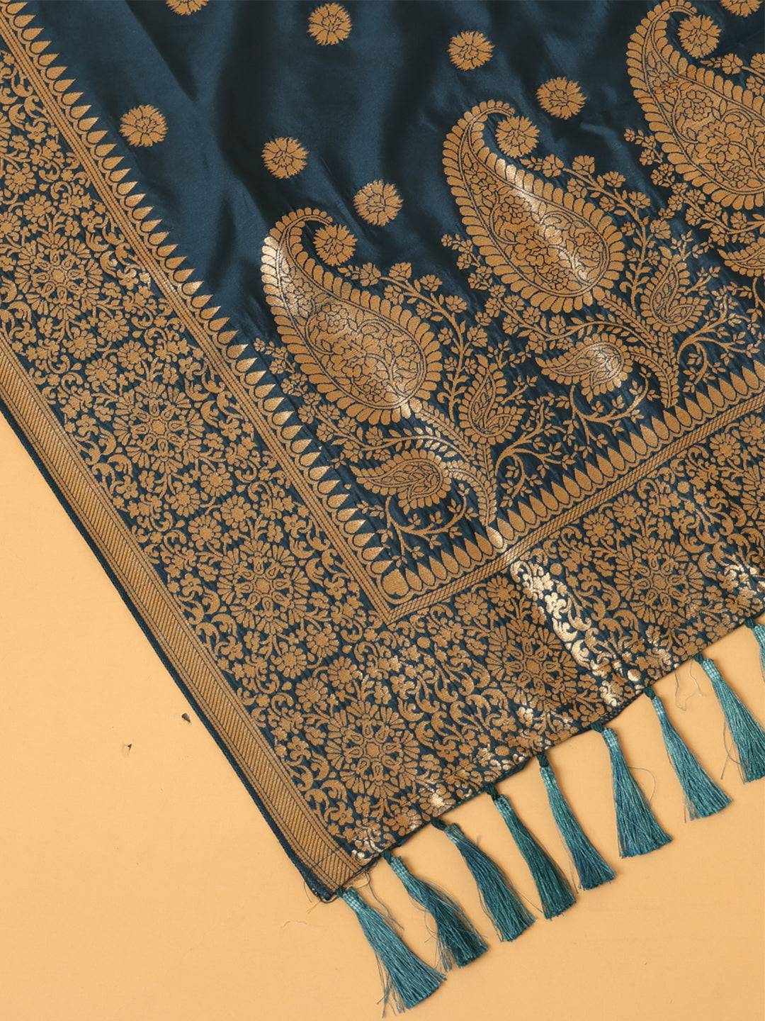 Close-up of teal dupatta's intricate woven pattern and tassels.