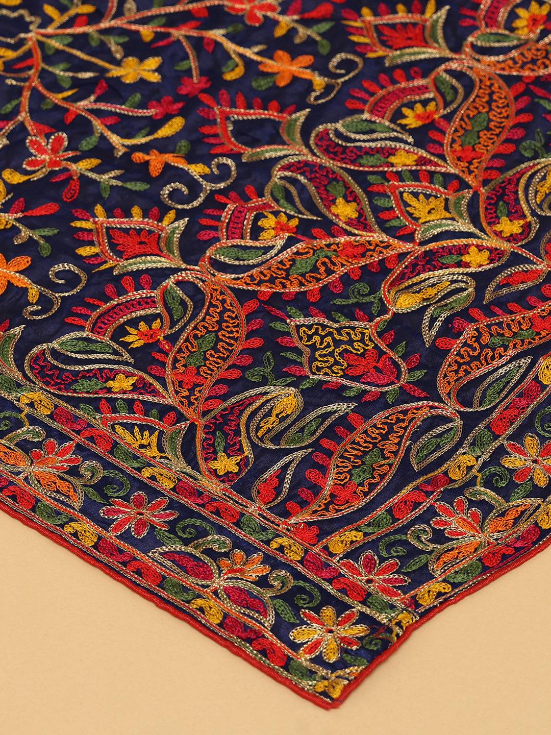 Close-up of navy blue dupatta's vibrant embroidered patterns