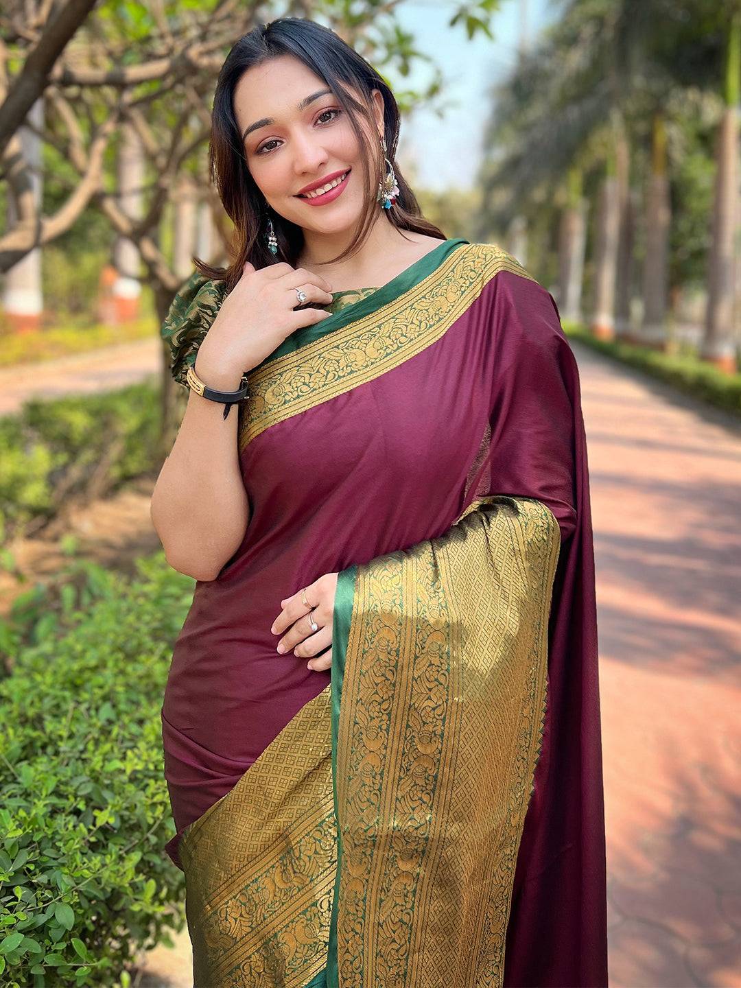Woman in wine Kanjivaram saree with gold weaving, outdoor setting