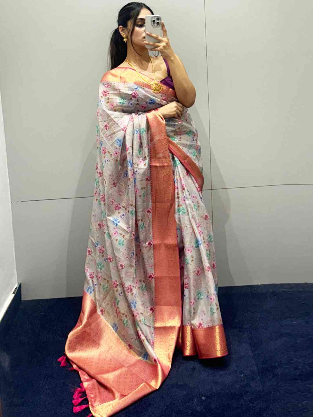 Woman in digital flower print Kota silk saree taking a selfie