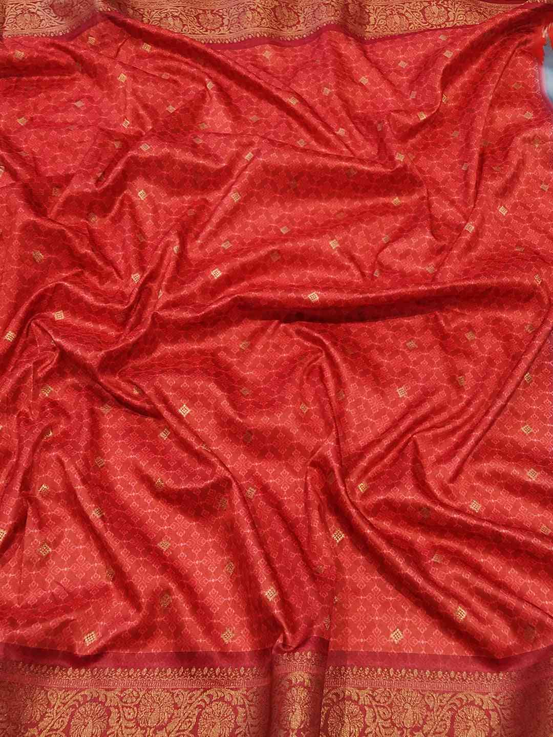 Rich red jacquard fabric with intricate Banarasi design