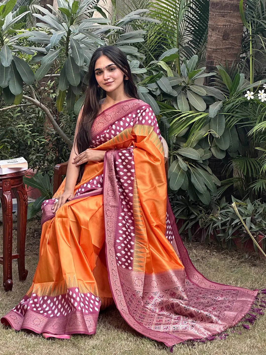 Orange Banarasi soft silk saree with Patola pallu, garden setting