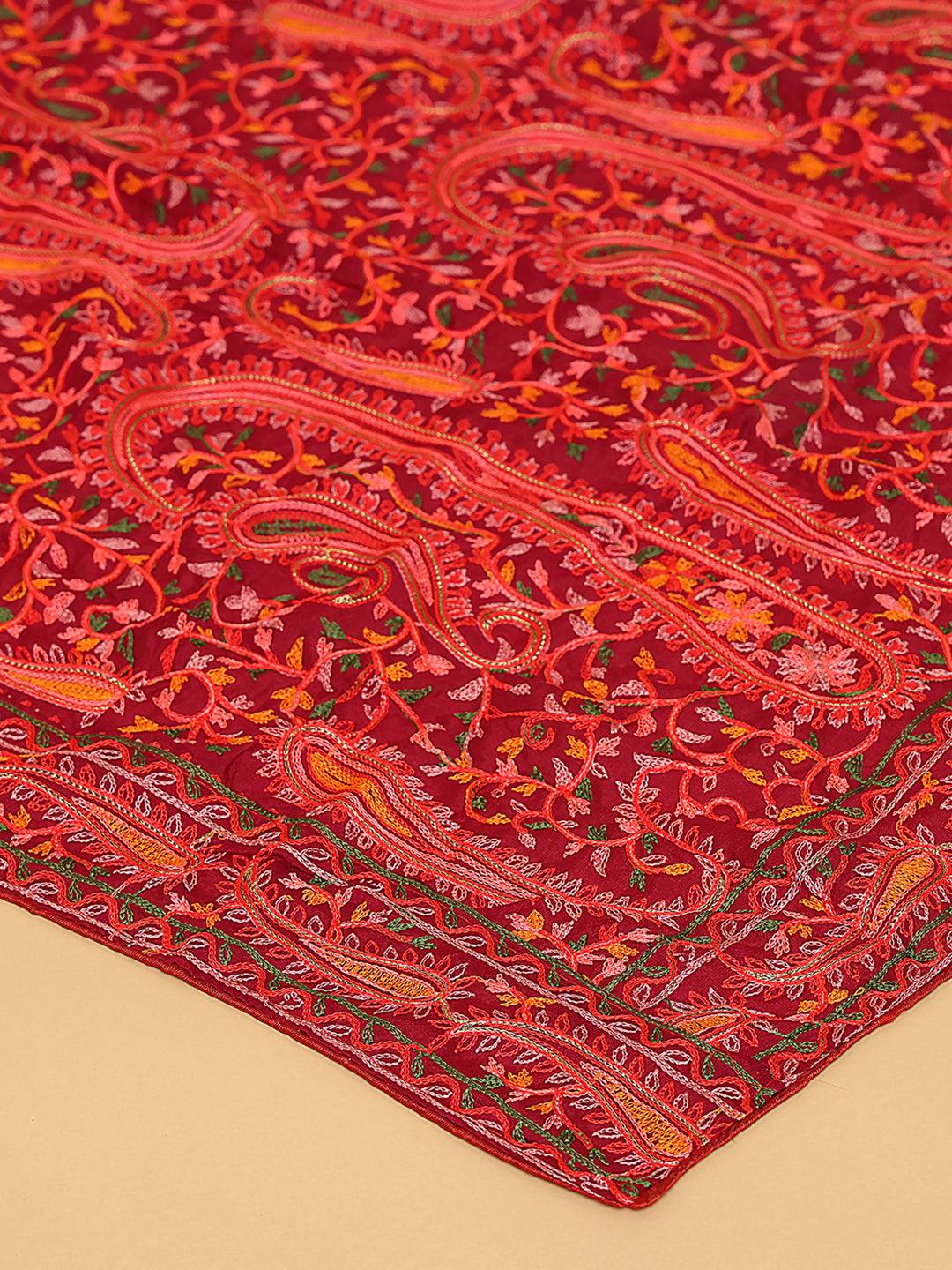 Close-up of red dupatta's intricate embroidery design.