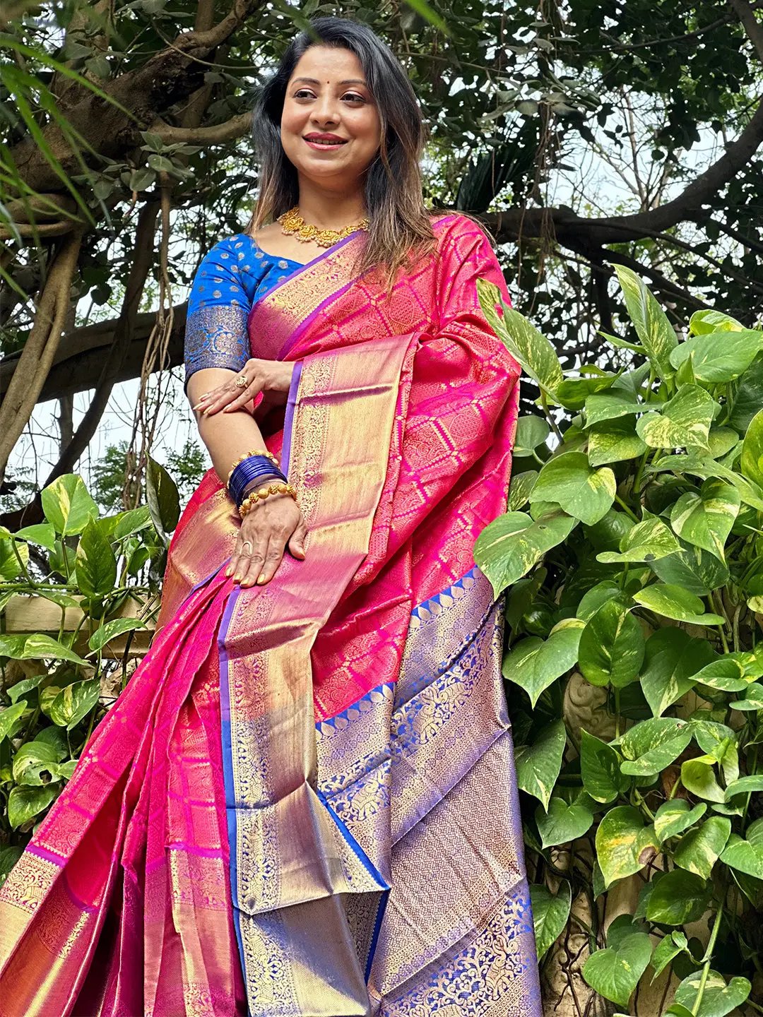 Model posing in checked Kanjivaram silk saree with zari