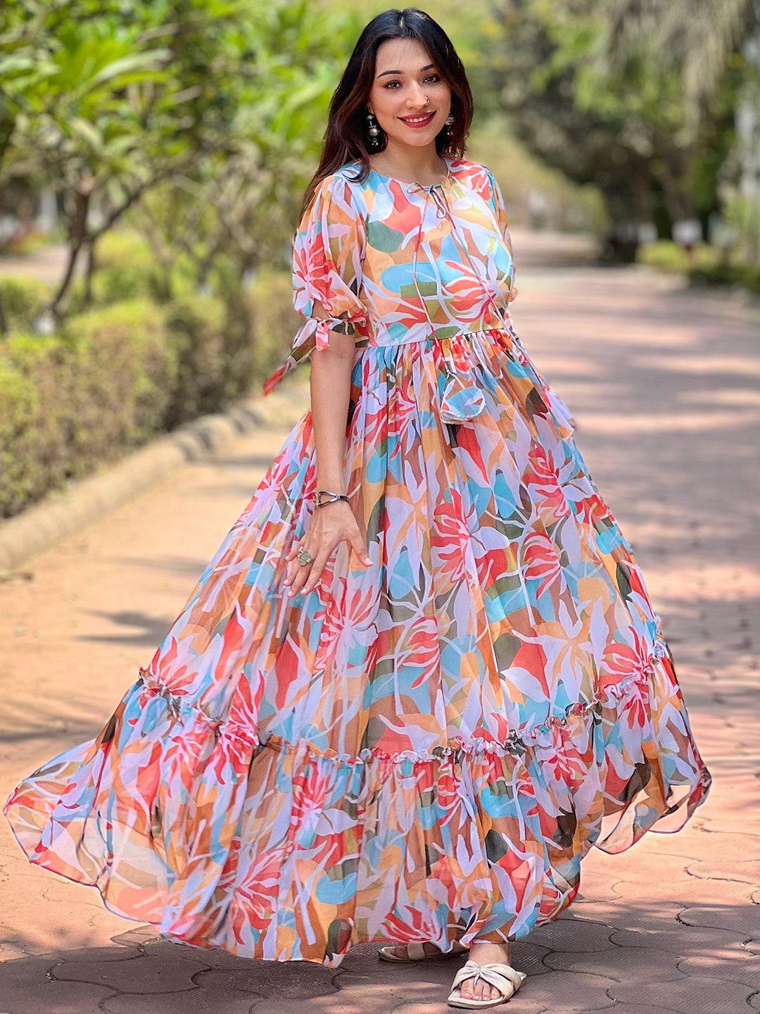Model wearing colorful abstract print dress on path