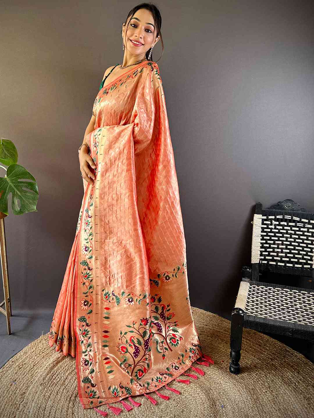 Model wearing peach silk blend Paithani saree with zari work