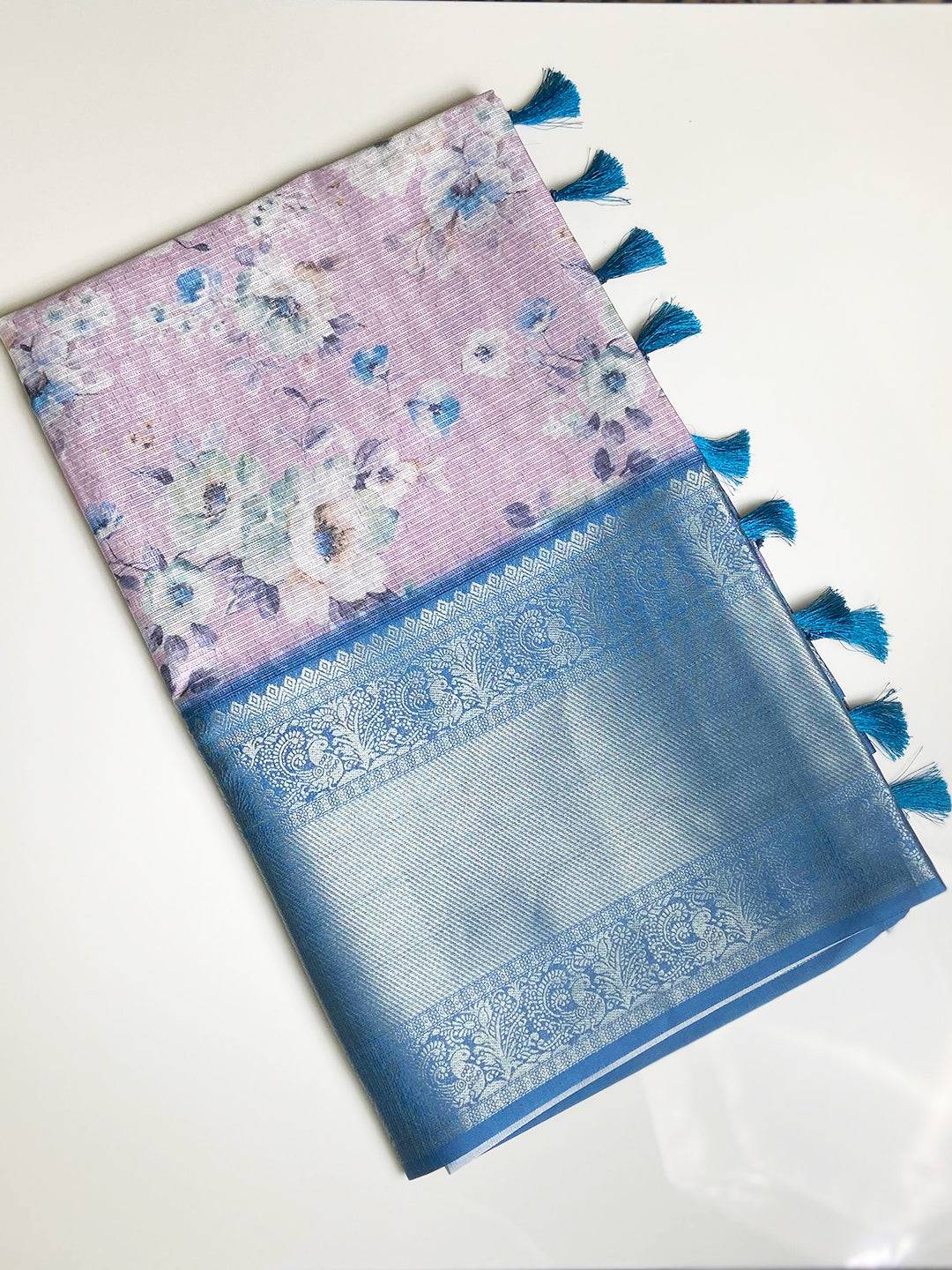 Folded floral saree with blue zari border and tassels