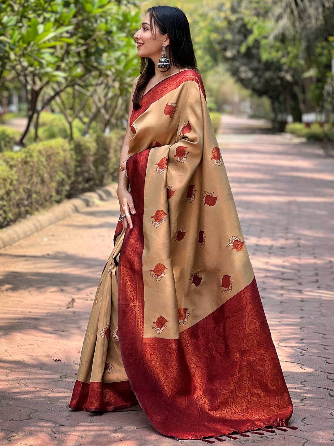 Side profile of woman in beige saree with red accents