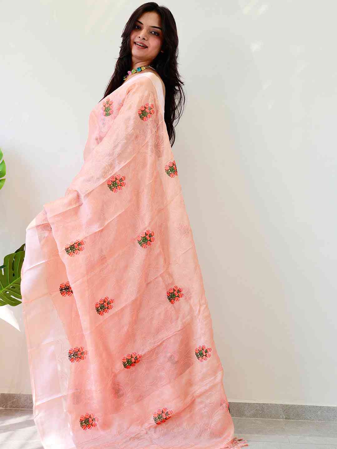 Side view of chiffon satin saree with flower embroidery.