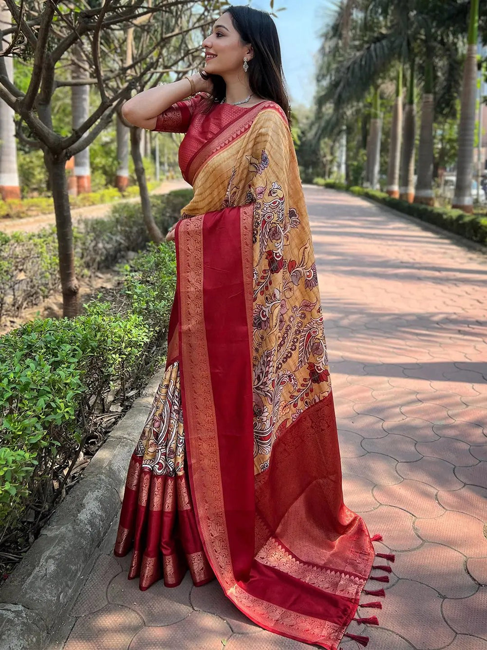 Stylish mustard Banarasi saree with red border and floral patterns.