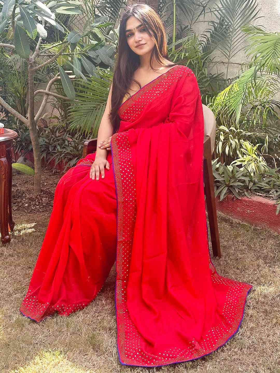 Red Vichitra Silk Saree with Swarovski Stones in garden setting